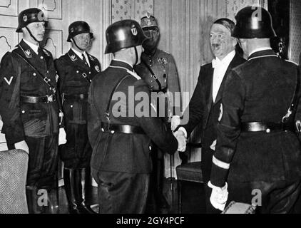 The chiefs of the police pay Hitler a visit on his birthday. From left: Reinhard Heydrich, Karl Wolff, Kurt Daluege. Hitler's hand is shaken by August Heißmeier, with Heinrich Himmler standing next to him. [automated translation] Stock Photo