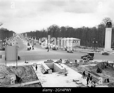 The east-west axis (today: Straße des 17. Juni) in Berlin-Mitte was decorated for Adolf Hitler's birthday parade. In this picture, taken on 15 April 1939 at the base of the Victory Column, the Brandenburg Gate can be seen in the background. [automated translation]
