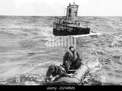 German aircrew in distress is rescued. In the background a distress buoy (so-called Udet buoy). Buoys of this type were laid out in the English Channel to offer ditched crews the possibility of rescue. They also had a lounge, so that the crews had protection from the weather. Photo:Dreesen [automated translation] Stock Photo