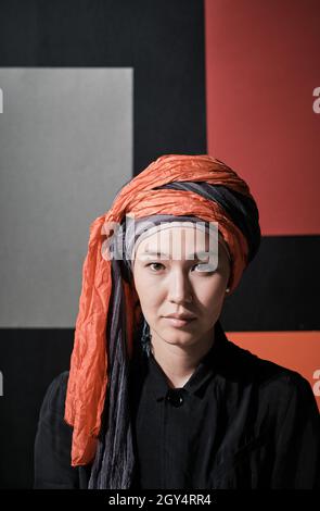 Close-up of young elegant woman in hijab looking at camera Stock Photo