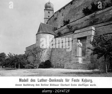 'The photograph from 1914 shows a model for a Luther memorial on the southwest side of the outer Zwingermauer of the Veste Coburg between two powder towers. Sculptor Eberhard Encke had made this model out of plaster and wood after a competition. The inscription on the architrave reads: ''I will not die / But live / And proclaim the works of the Lord''. Luther had written these words of the psalm in the niche of his window during his stay at the Veste in 1530. On the pedestal is written: ''The word they should / let stand''. The monument was to be completed by 1917, in time for the four Stock Photo