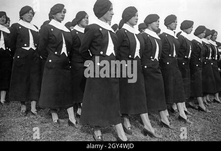 A group of young women from the fascist Opera Nazionale Balilla lined up in formation in a meadow in 1935. [automated translation] Stock Photo