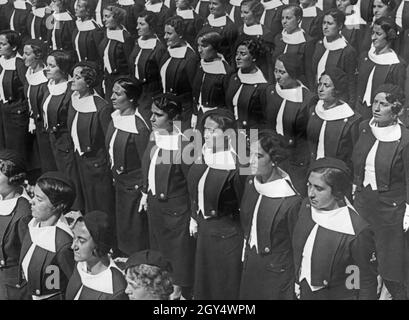 'A group of young women belonging to the Giovani Fasciste, a fascist organization for women aged 18 and over, stand uniformly in line. They are students at the ''Accademia fascista'' (Fascist Academy) in Orvieto, Italy. Undated photograph, probably taken around 1935. [automated translation]' Stock Photo