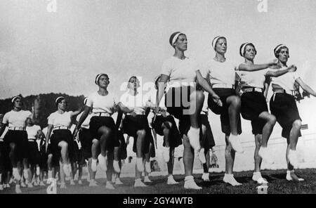 'A group of young women practice marching in parade step in a meadow near Orvieto in Italy in 1936. The students (''Giovani Accademiste'') go to the ''Scuola di Educazione Fisica Femminile di Orvieto''. [automated translation]' Stock Photo