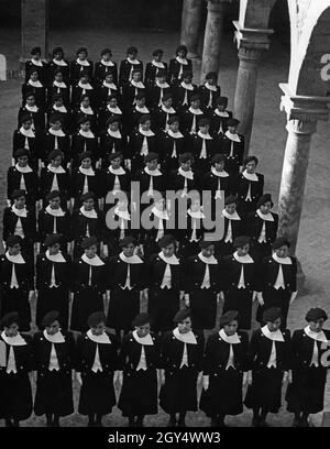 'A group of young women belonging to the Giovani Fasciste, a fascist organization for women over the age of 18, stand uniformly in line. They are standing in the courtyard of the academy, which is built into an old convent. The academy is probably the ''Accademia fascista'' (Fascist Academy) in Orvieto, Italy. Undated photo, probably taken around 1935. [automated translation]' Stock Photo