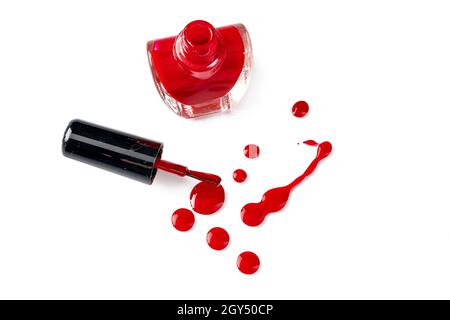 Bright colored nail polish bottles with drippings on white background Stock Photo
