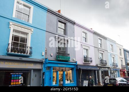 Colourful pastel shades on terraced houses on Portobello Road, Royal Borough of Kensington and Chelsea, London, England, UK Stock Photo