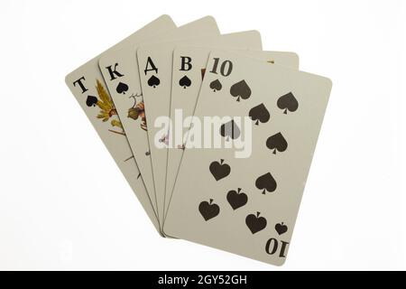 Five playing cards fanned out in the center of the frame on a white clipping background. Black of spades Stock Photo