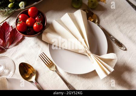 Reserved Thanksgiving or Halloween place setting at a farmhouse table set with season vegetables, Stock Photo