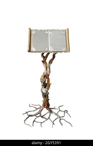 A beautiful decorative iron stand for books in the form of a tree trunk and root with unfolded pages of a book. On a white background for clipping. Stock Photo