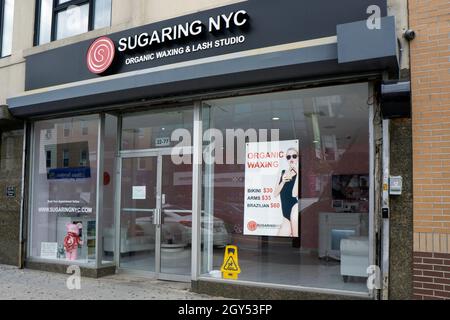The exterior of Sugaring NYC, an organic waxing & Lash Studio on Steinway Street in Astoria, Queens, New York city. Stock Photo