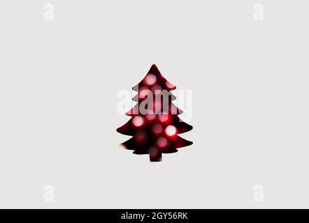 Defocus abstract christmas tree background. Art Christmas tree paper cutting design vintage card. Holiday, abstract. Red bokeh inside.Out of focus. Stock Photo