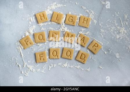Wheat pastry squares spelling out 'High Fodmap Food'. Stock Photo