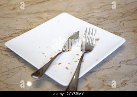 cutlery and empty plate on wooden background  Stock Photo