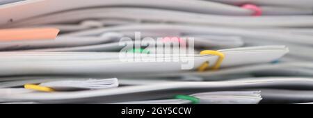 Stack of reporting paper documents on desktop Stock Photo