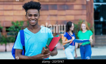 Laughing african american male student with group of international students outdoor in city Stock Photo