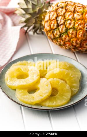 Canned sliced pineapple fruit on plate. Stock Photo