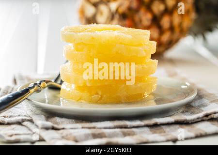 Canned sliced pineapple fruit on plate. Stock Photo