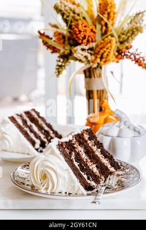 Chocolate vanilla layer cake on a plate with a cake fork Stock Photo