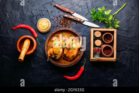 Roasted whole quail and spring vegetable salad Stock Photo