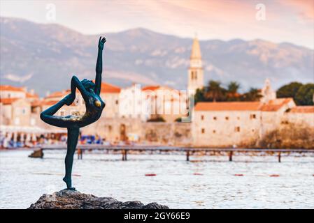 Sculpture of dancer girl in Budva, Montenegro, Balkans, Europe. Old town and mountains in backround. Stock Photo