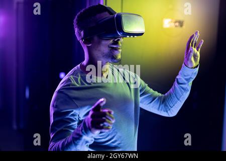 African american male computer technician wearing vr headset and working in server room Stock Photo