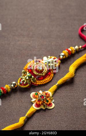 Raksha Bandhan background with an elegant Rakhi. A traditional Indian wrist band Stock Photo