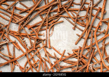Rusty used nails on a cement metal background Stock Photo