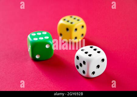 Three colorful dices isolated on pink background Stock Photo