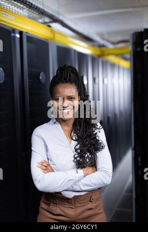 Portrait of african american female computer technician working in server room Stock Photo