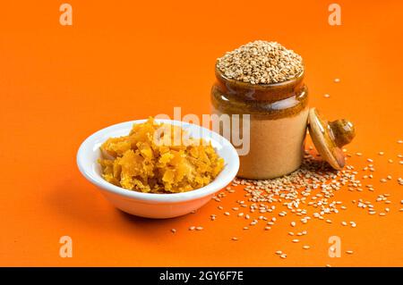 Sesame Seeds in clay pot with Jaggery in bowl Stock Photo