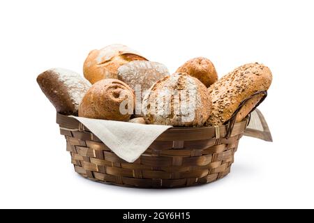 assortment of baked bread in straw basket on white background Stock Photo