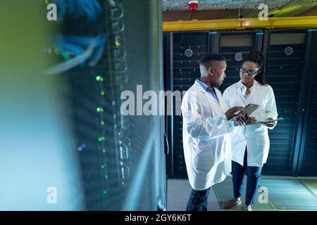 African american computer technicians using tablet working in server room Stock Photo