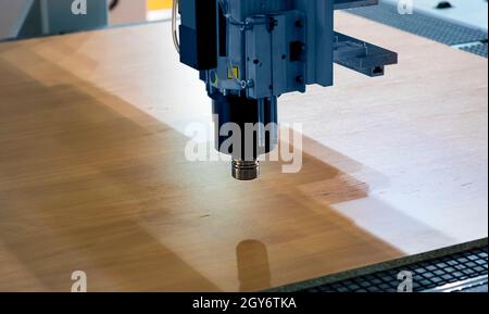 Milling a wooden board. Processing of wood panels on CNC coordinate milling woodworking machines. CNC woodworking machine Stock Photo