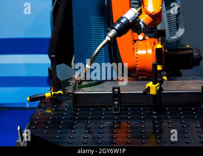 Automatic robotic arm for metal welding operations. Stock Photo