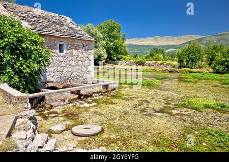 Old stone mill ruins on Cetina river source, Dalmatian Zagora region of Croatia Stock Photo