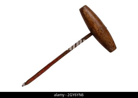 Antique hand drill isolated. Close-up of a vintage rusty hand drill with wooden handle isolated on a white background. Macro of old carpenter wooden h Stock Photo