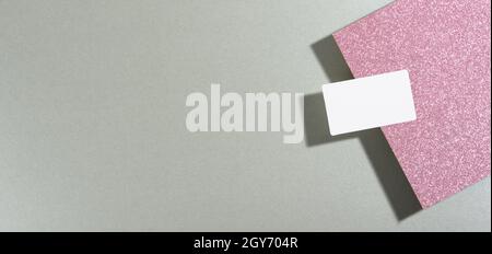 blank rectangular business card lies on a modern gray background sheets of paper with a shadow. Business template, flat lay Stock Photo