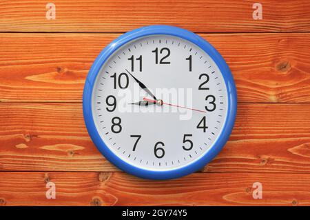 Blue vintage wall clock on a wooden background Stock Photo