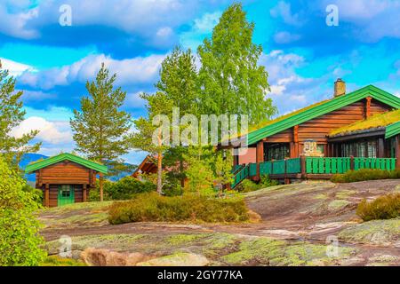 Norwegian wooden cabins cottages in the nature and mountain landscape of Treungen in Nissedal Norway. Stock Photo