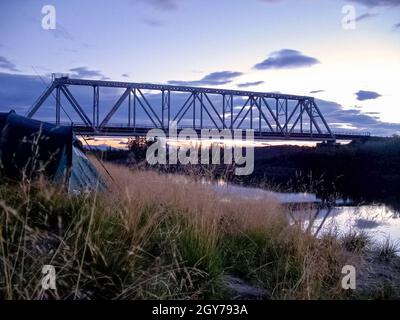Railway bridge across the river. Steel construction Stock Photo