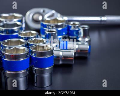 block wrench set and ratchet wrench on a black background. Stock Photo
