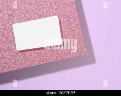 blank rectangular business card lies on a modern purple background sheets of paper with a shadow. Business template, flat lay Stock Photo