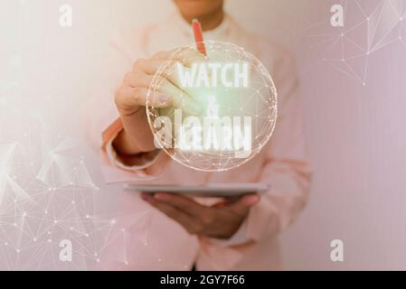 Text caption presenting Watch And Learn, Business showcase demonstrating an action or ideas of how to do things Inspirational business technology conc Stock Photo