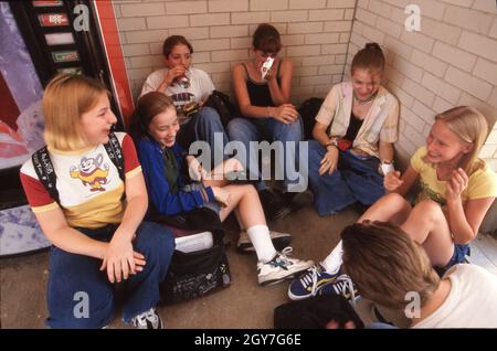 Austin Texas USA, circa 1998: Middle school students socialize during their lunch period. ©Bob Daemmrich Stock Photo