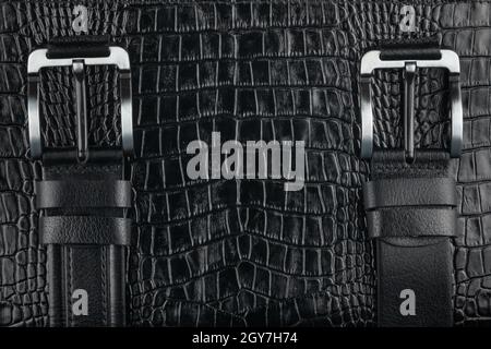 Two belt lying on crocodile skin, can be used as background Stock Photo