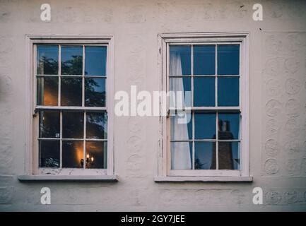 Two double hung windows of a white house in Cambridge England Stock Photo