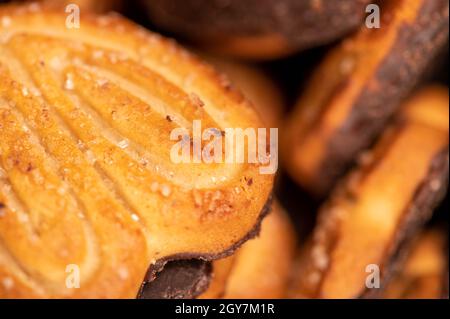 Curly cookies covered with chocolate icing, background image, close-up, selective focus Stock Photo