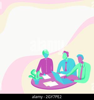 Colleagues Drawing Sitting On A Desk With Laptop Having Discussion. Stock Photo