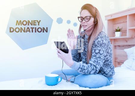 Text sign showing Money Donation, Business approach a charity aid in a form of cash offered to an association Entrepreneur Checking And Reading Emails Stock Photo